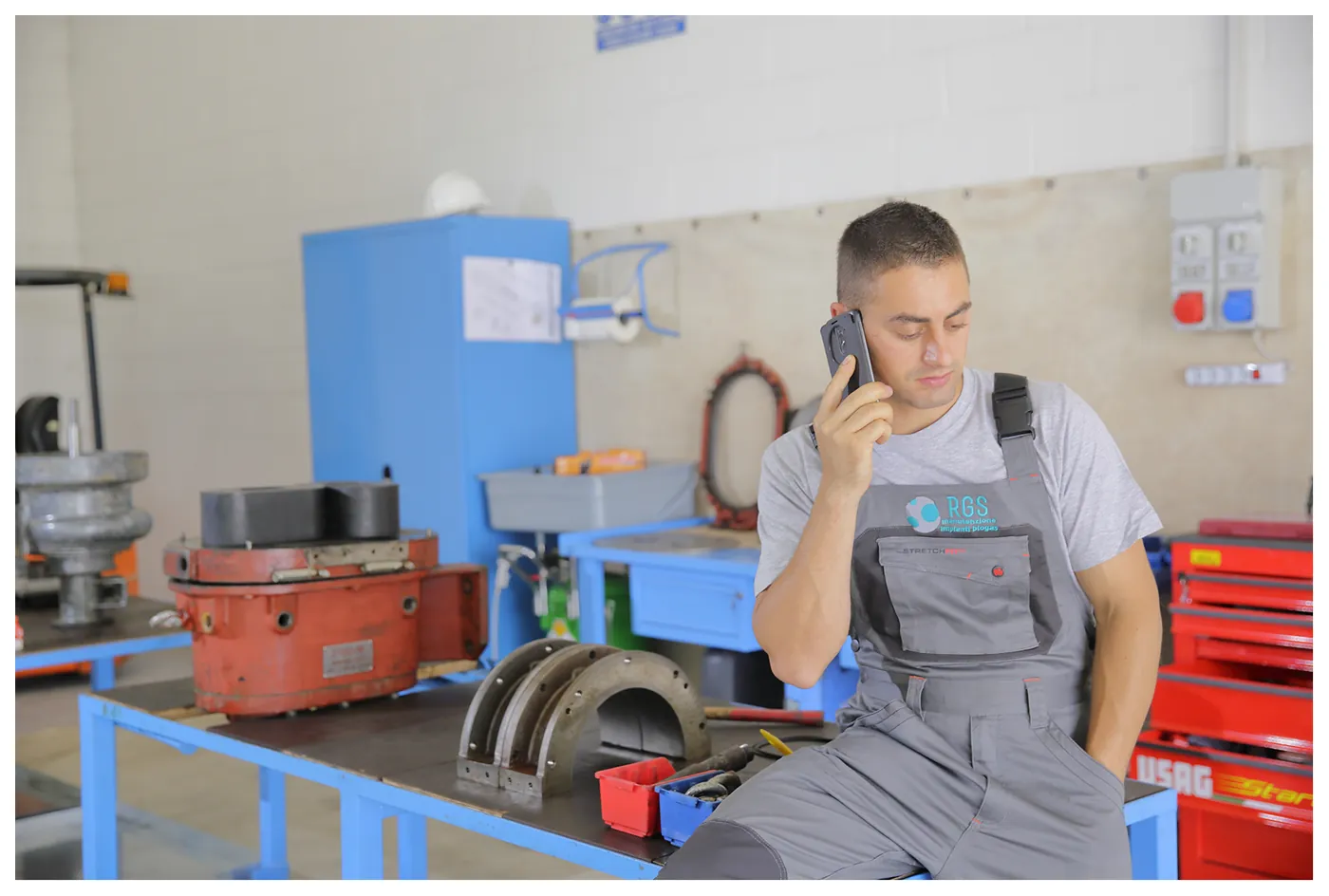 Tecnico RGS al telefono nell'officina organizza un intervento